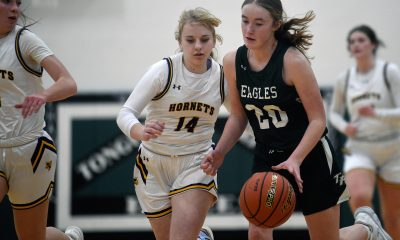 Tongue River Lady Eagles' Payton McRann and a Pine Bluff Lady Hornet crash into each other during their game.