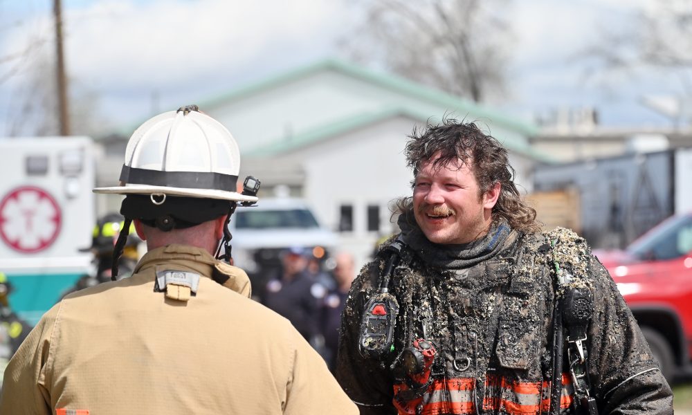 Sheridan Fire-Rescue's Collin Eisenman manages to smile as he chats with a fellow firefighter after battling a structure fire in an apartment complex fire at the intersection of 11th Street and North Main Street Thursday, April 23, 2026. He said the ceiling became the floor.
