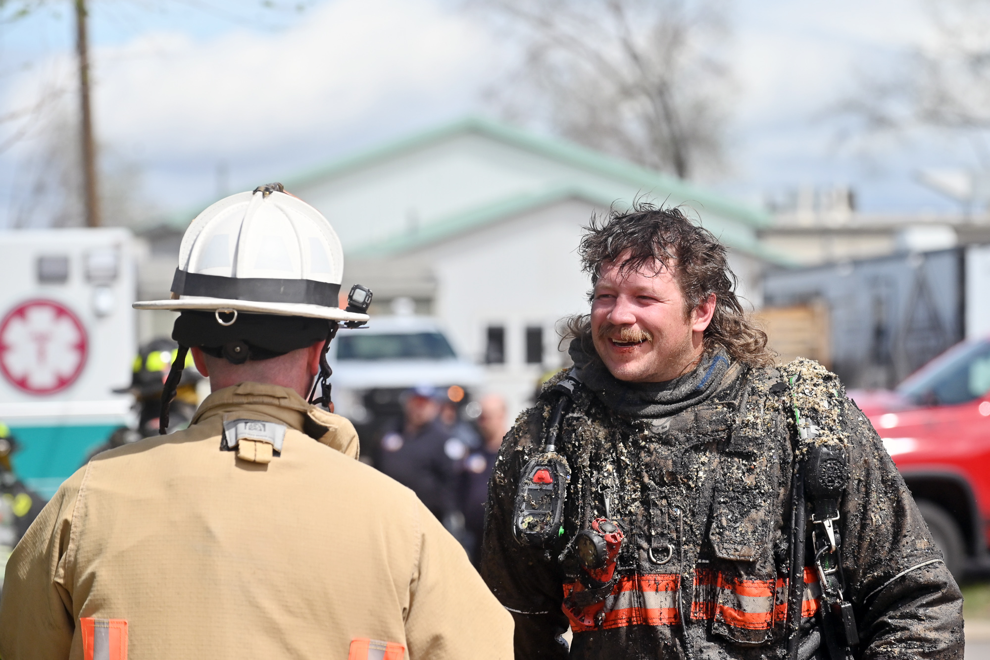 Sheridan Fire-Rescue's Collin Eisenman manages to smile as he chats with a fellow firefighter after battling a structure fire in an apartment complex fire at the intersection of 11th Street and North Main Street Thursday, April 23, 2026. He said the ceiling became the floor.